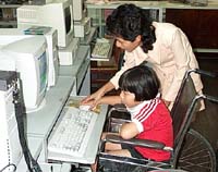Kid with Celebral Palsy at the computer.